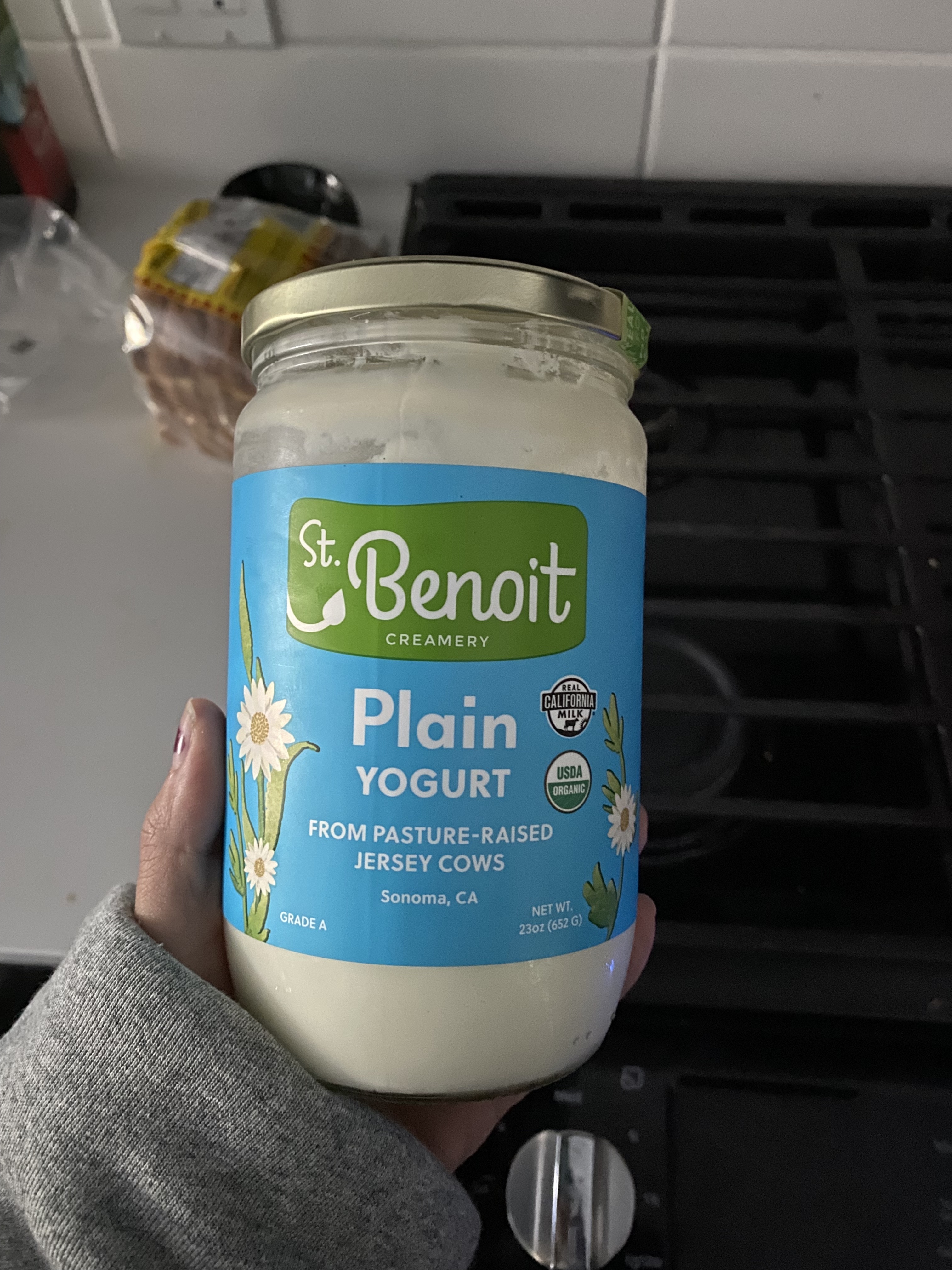 A photo of yogurt in a tall glass jar